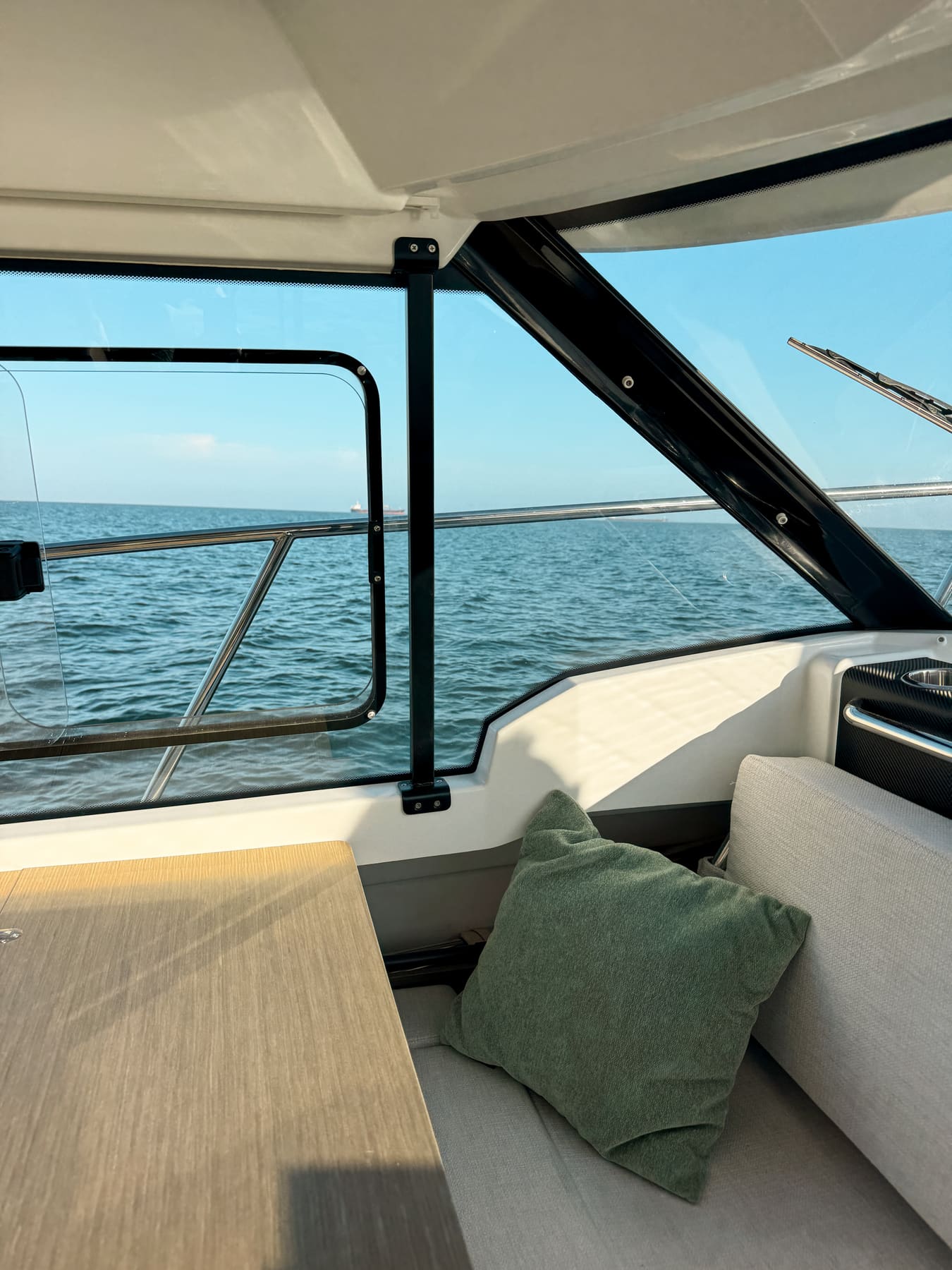 View out to the calm Atlantic from the comfortable cabin of a private boat on a sunset cruise in Cascais