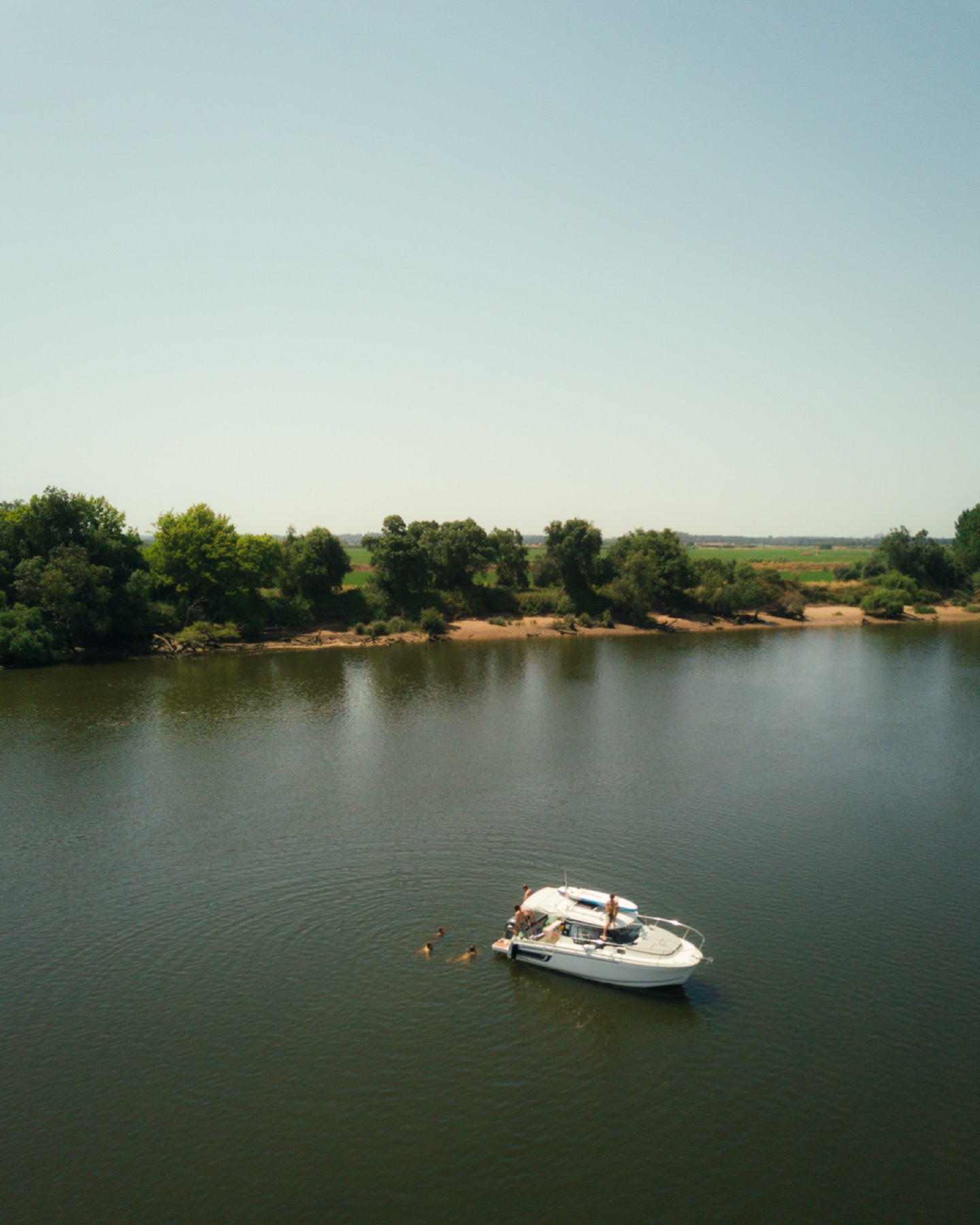 Aerial view of a private boat anchored on the Tejo river near Valada with guests swimming in the calm water
